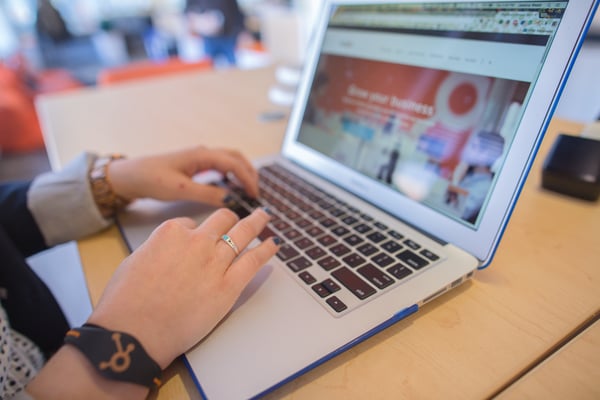 hands typing on a laptop